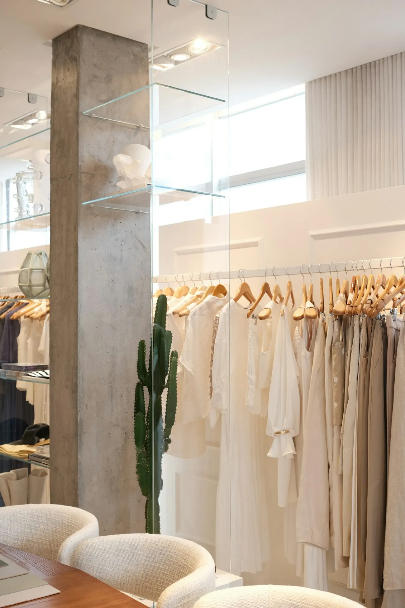 Boutique rail of neutral-toned dresses in a bright store