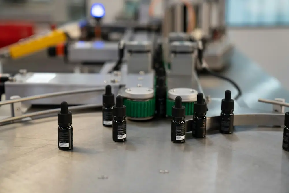 Small dropper bottles moving along an automated filling line