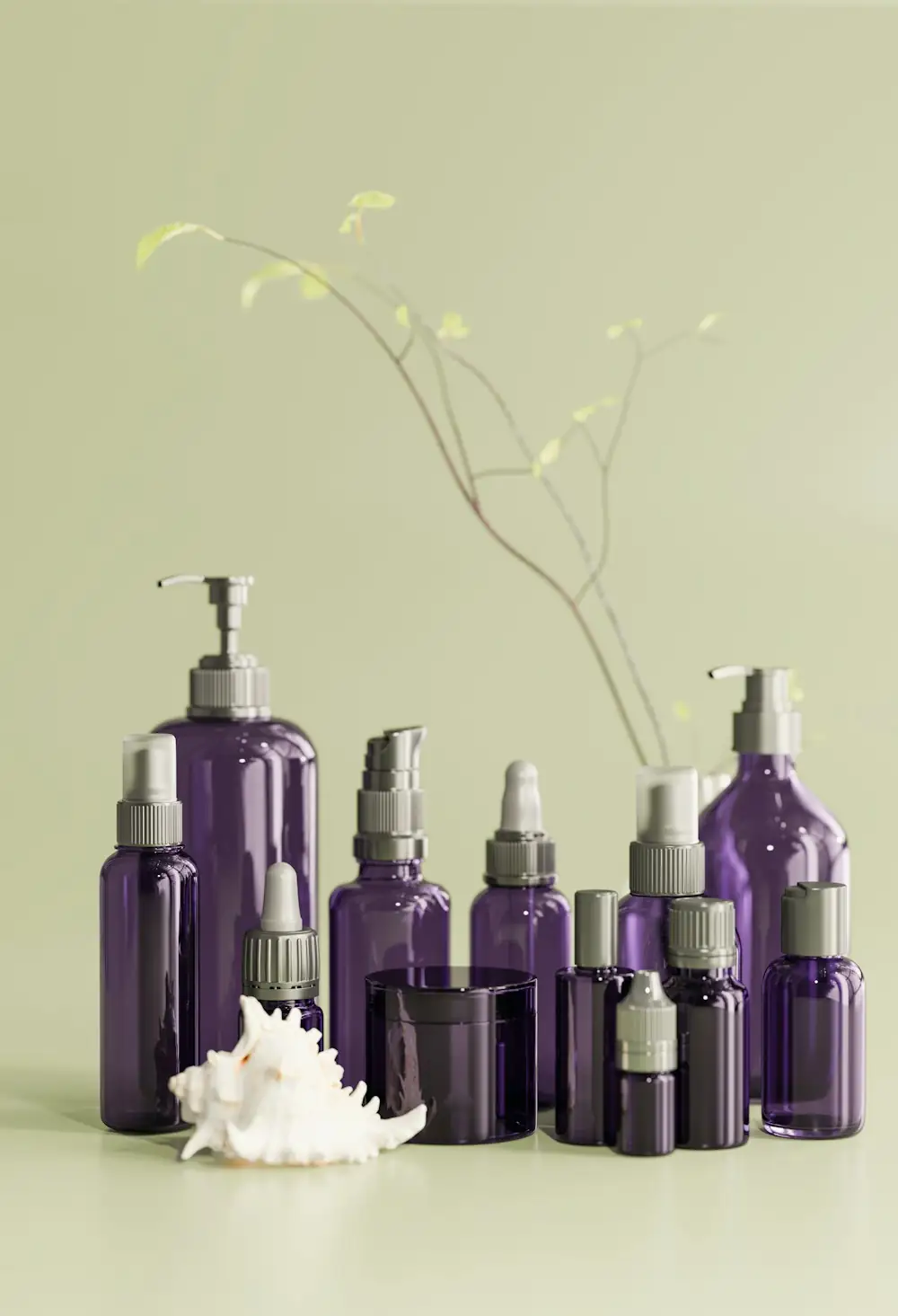 Purple glass cosmetic bottles of different sizes on a pale green background