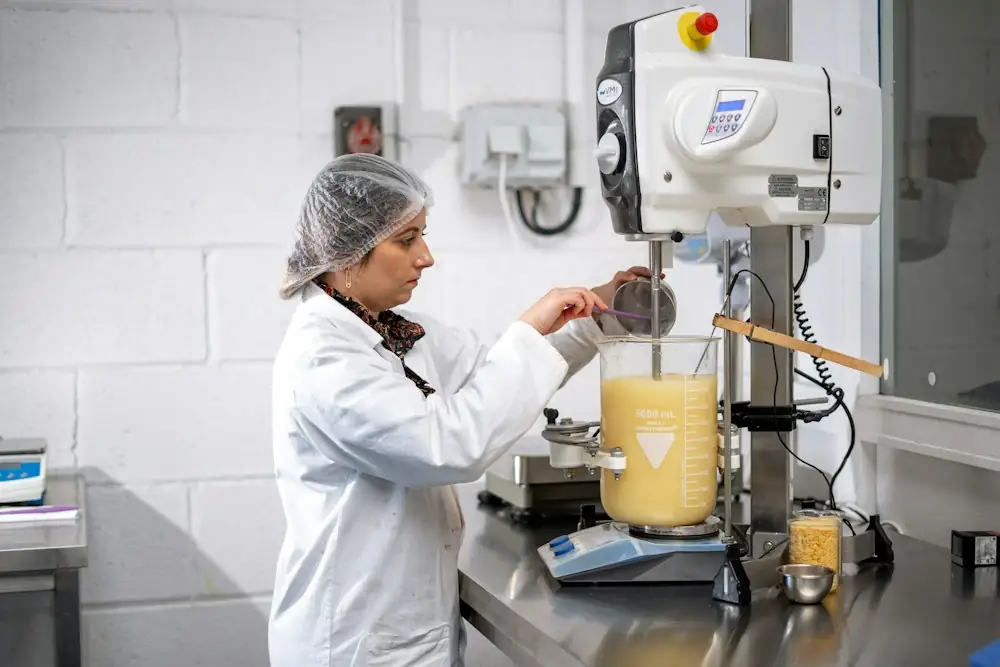 Lab technician mixing a cosmetic formula in a beaker