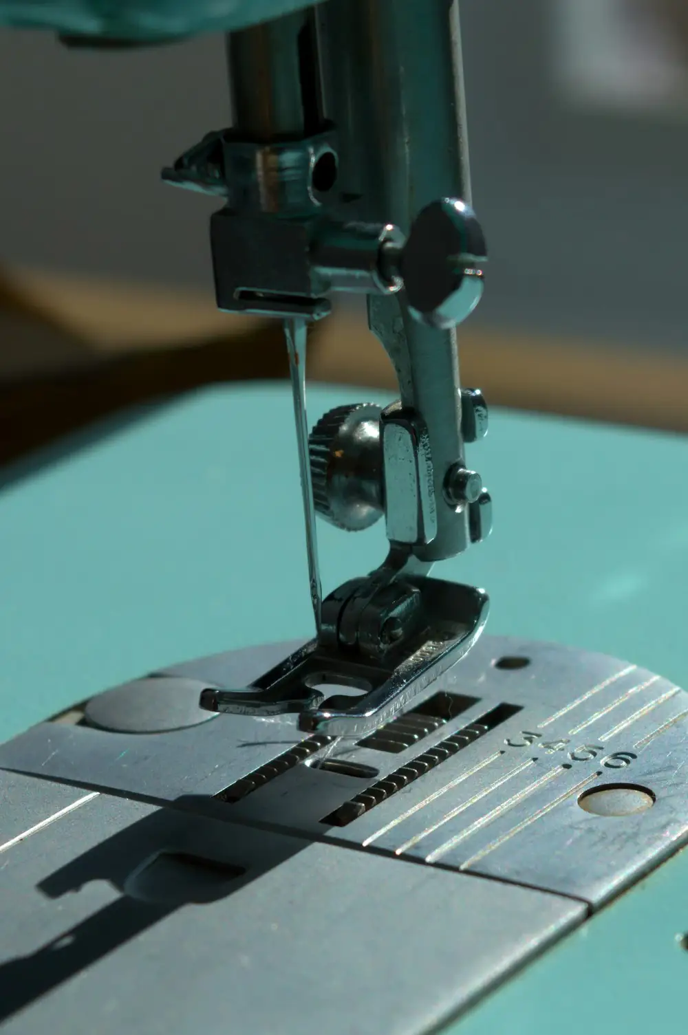Sewing machine needle and presser foot mid-stitch