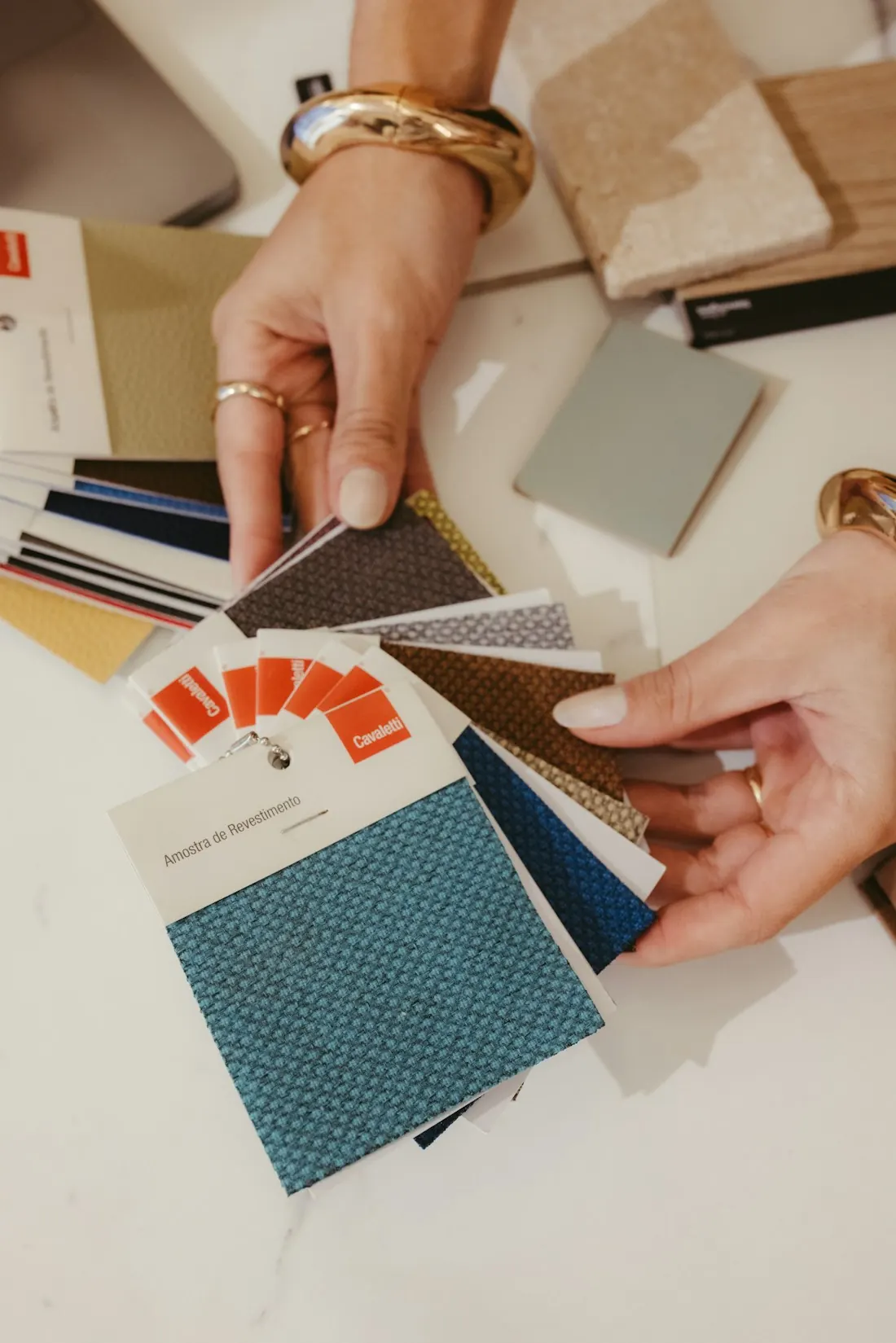Hands choosing fabric and colour swatches