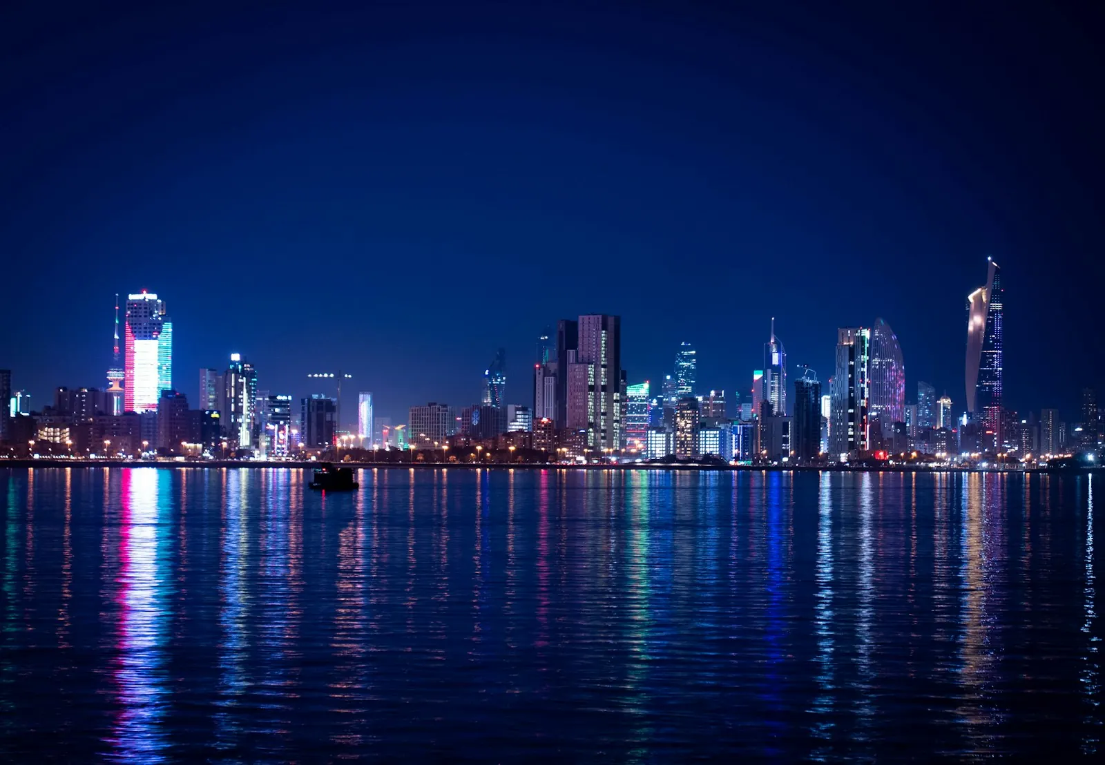Kuwait City skyline lit at night across the water