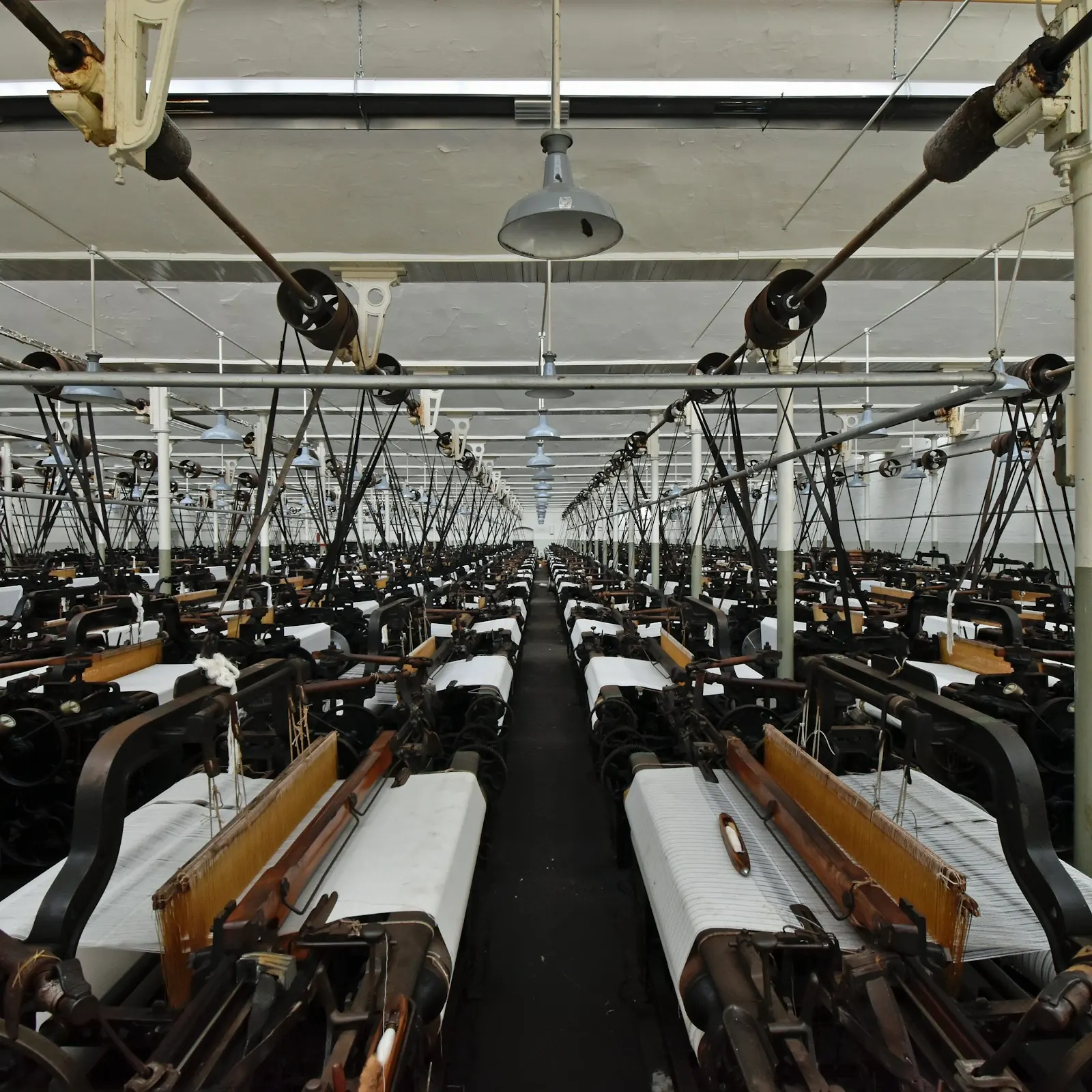 Rows of looms stretching down a weaving mill