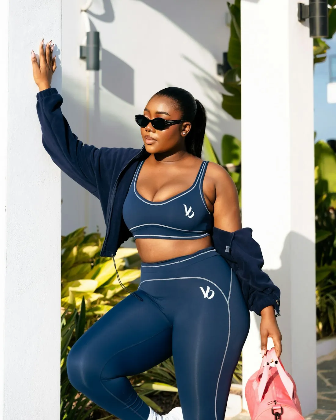 Woman in a navy sports bra and leggings set