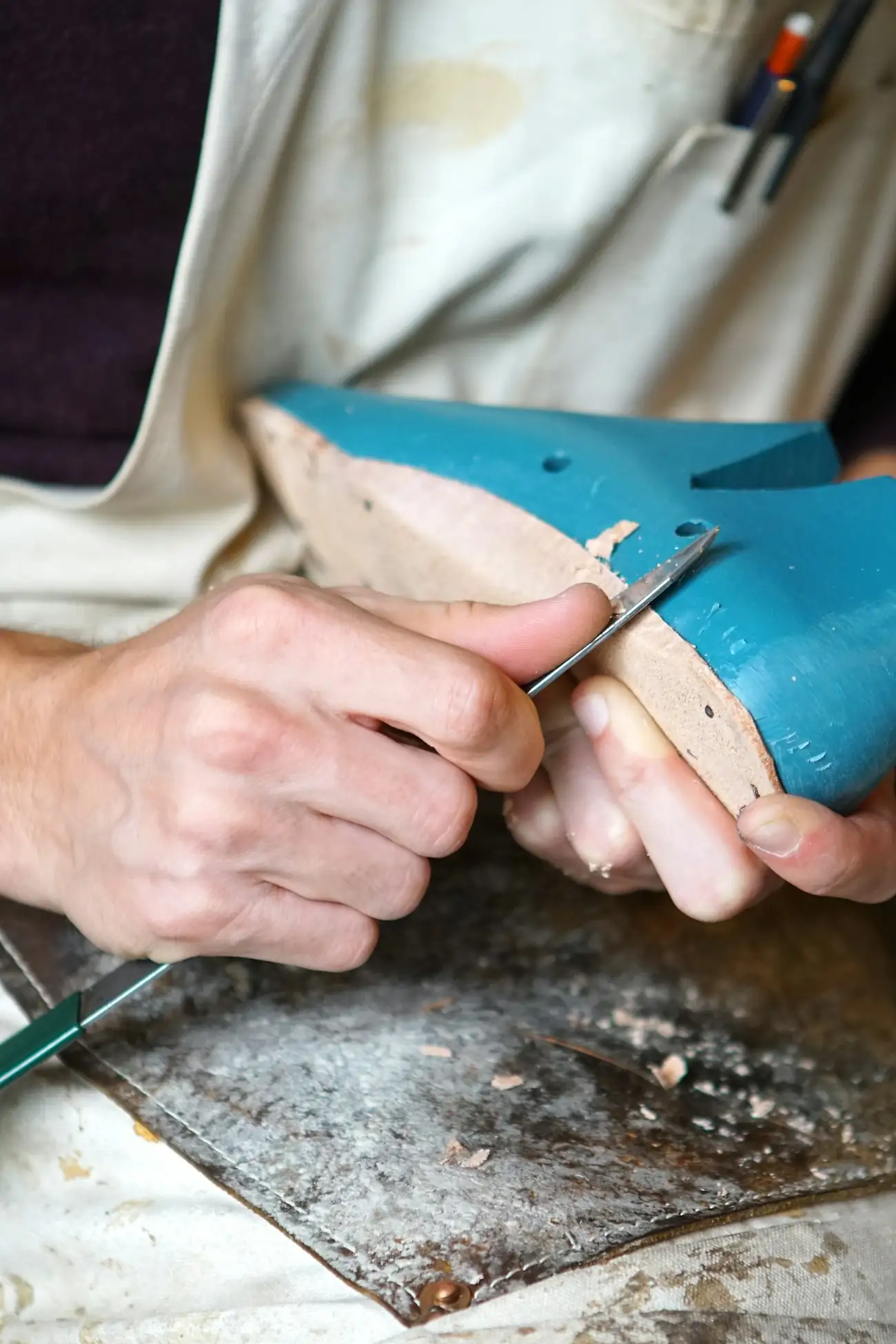 Craftsman shaping a shoe upper on a last