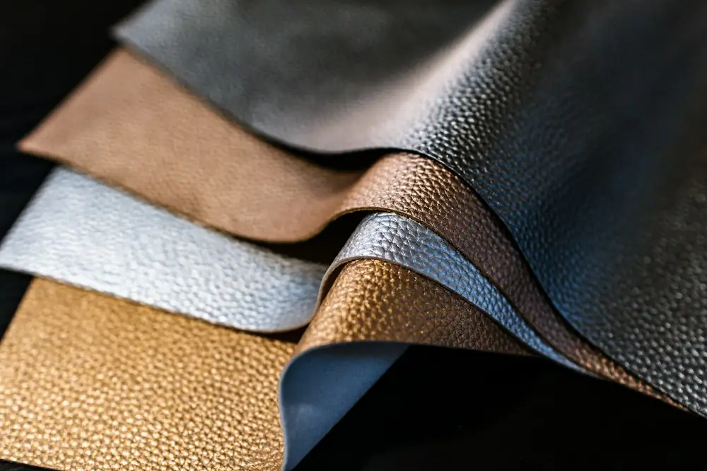 Stack of leather swatches in brown, grey and gold