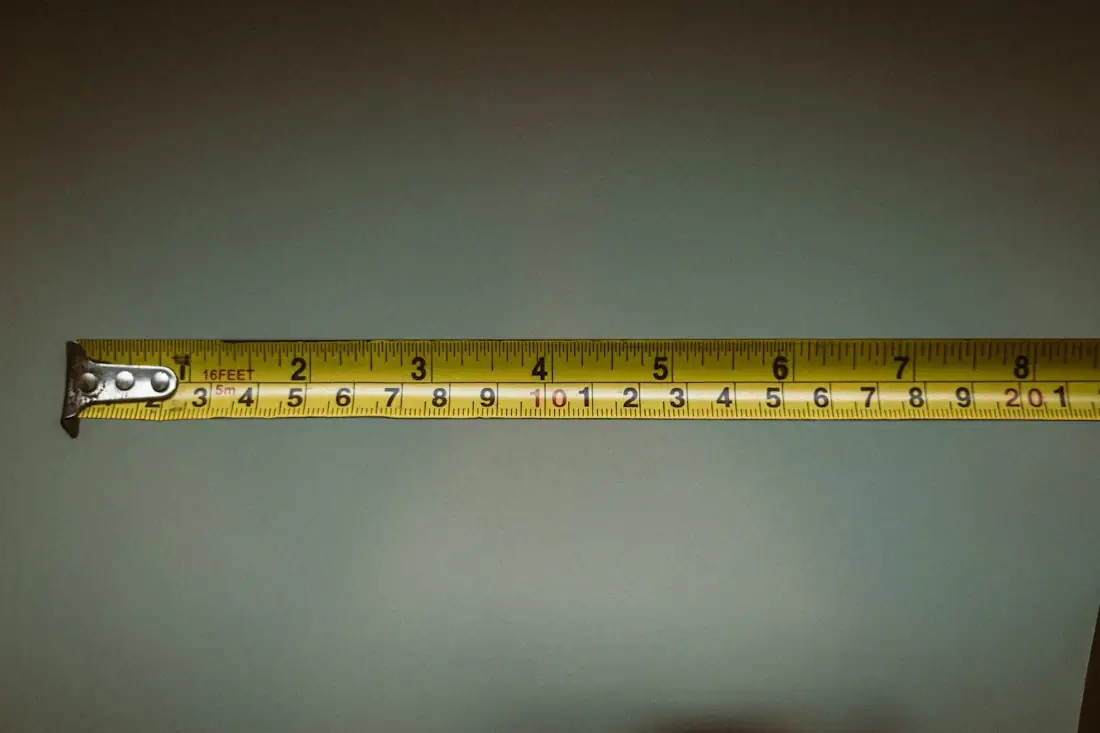 Tape measure stretched out on a dark surface