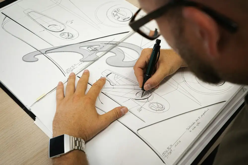 Designer drawing a jewelry sketch in a notebook