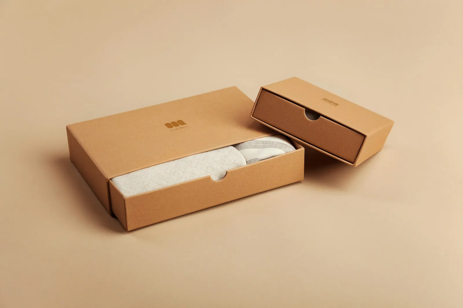 Kraft retail box sliding open with a folded garment inside