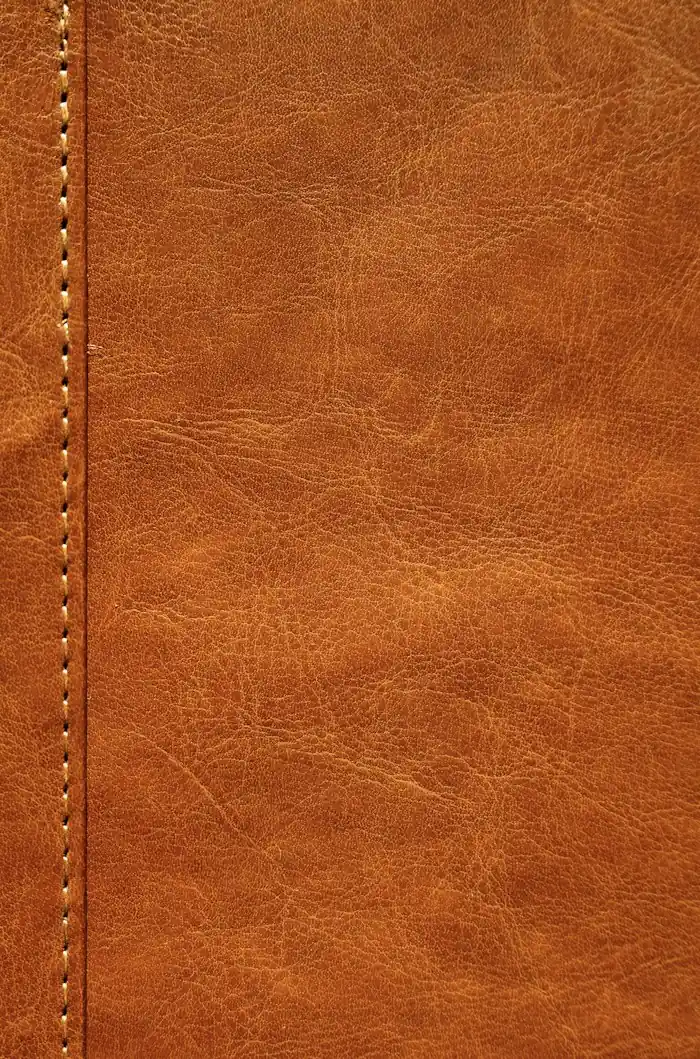 Orange-brown leather with a visible row of stitching