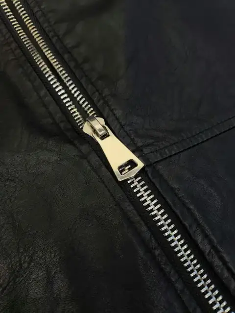 Close-up of a metal zipper on a dark garment